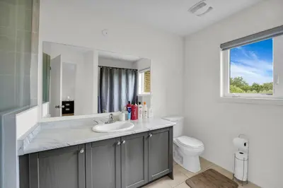 a bathroom with a sink and a toilet at Spacious Family Friendly Vacation home in Brampton