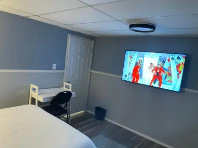 a room with a flat screen tv on a wall at Travelers Home in Oshawa