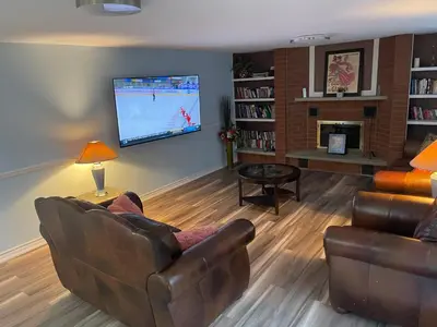 a living room with a couch and a flat screen tv at Travelers Home in Oshawa