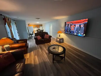 a living room with a flat screen tv on the wall at Travelers Home in Oshawa