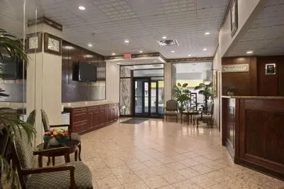 a lobby with a waiting area with chairs and tables at Travelodge by Wyndham Cambridge - Waterloo in Preston