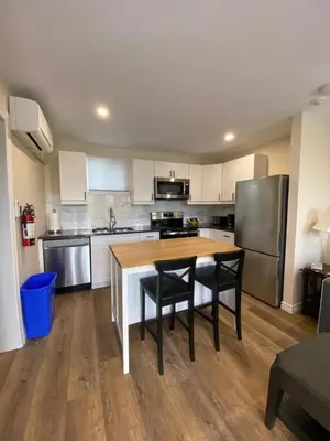 a kitchen with a table and chairs and a refrigerator at Motel 400 & Suites in Innisfil