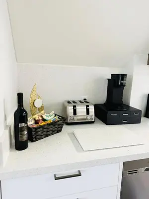 a kitchen counter with a toaster and a basket of food at Dufferin Serenity Suite in Toronto