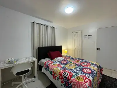 a bedroom with a bed with a desk and a bed sidx sidx sidx at Toronto Room with Balcony - Midtown in Toronto