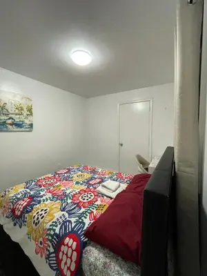 a bedroom with a bed with a colorful comforter at Toronto Room with Balcony - Midtown in Toronto