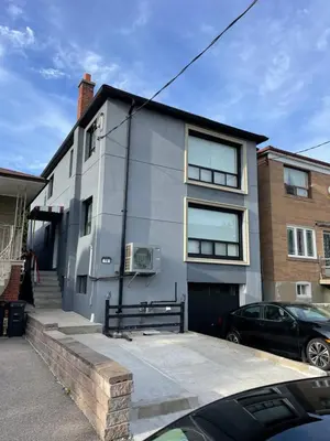 a house with a car parked in front of it at Toronto Room with Balcony - Midtown in Toronto