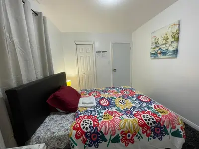 a bedroom with a bed with a colorful comforter at Toronto Room with Balcony - Midtown in Toronto