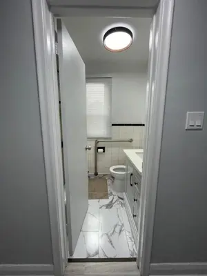 a white bathroom with a toilet and a sink at Toronto Room with Balcony - Midtown in Toronto