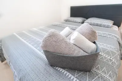 a bed with two beds with towels on it at Frybrook in Richmond Hill