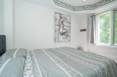 a white bedroom with a bed and a window at Frybrook in Richmond Hill