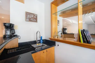 a kitchen with a sink and a mirror at Frybrook in Richmond Hill