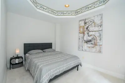 a bedroom with a bed and a painting on the wall at Frybrook in Richmond Hill