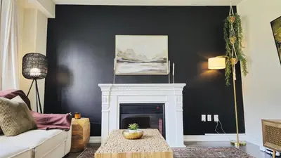 a living room with a fireplace and a black wall at 5beds 2800 sqft house, sleeps 11, 18 mins to falls in Thorold