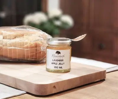 a jar of honey next to a loaf of bread at Vintage Farmhouse with Hot Tub on Vineyard in Waterford