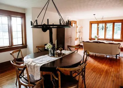 a dining room with a table and some chairs at Vintage Farmhouse with Hot Tub on Vineyard in Waterford