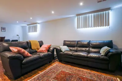 a living room with two leather couches and a couch at 1,200sq ft comfy home, perfect location, luxury bedding, feels like home! in Mississauga