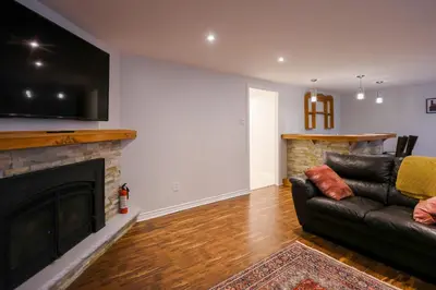 a living room with a couch and a fireplace at 1,200sq ft comfy home, perfect location, luxury bedding, feels like home! in Mississauga