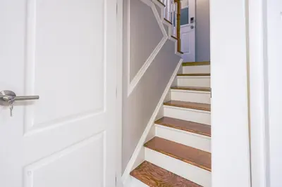 a stairwell with white walls and a white door at 1,200sq ft comfy home, perfect location, luxury bedding, feels like home! in Mississauga