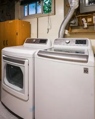 a stove and a washing machine in a kitchen at 1,200sq ft comfy home, perfect location, luxury bedding, feels like home! in Mississauga