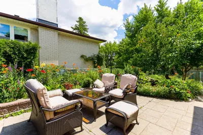 a patio with a group of chairs and a table at 1,200sq ft comfy home, perfect location, luxury bedding, feels like home! in Mississauga