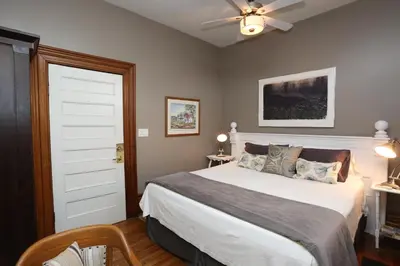 a bedroom with a bed and a ceiling fan at Danby House in Markdale