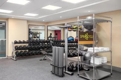 a gym with a rack of dumbbells at Home2 Suites By Hilton Kitchener in Kitchener