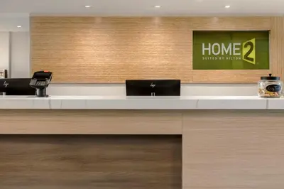 a lobby with two laptops on a counter at Home2 Suites By Hilton Kitchener in Kitchener