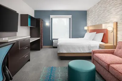 a hotel room with a bed and a couch at Home2 Suites By Hilton Kitchener in Kitchener