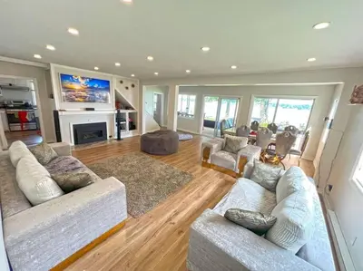 a large living room with couches and a fireplace at Charming Cottage on Lake Simcoe in Orillia