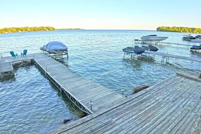 a dock in the middle of a lake with boats at Charming Cottage on Lake Simcoe in Orillia