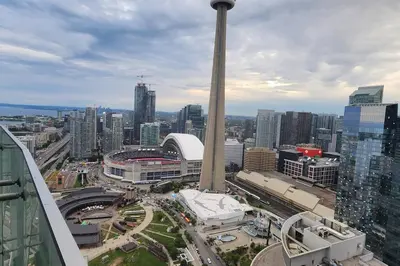 a view of a large city with a tall pole at Modern studio High Floor ,CN Tower, ScotiaArena in Toronto