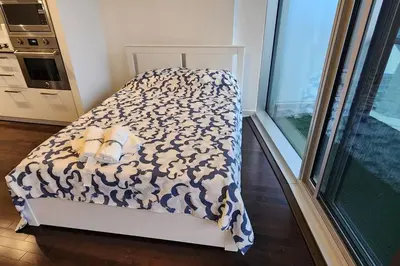 a bed in a room with at Modern studio High Floor ,CN Tower, ScotiaArena in Toronto