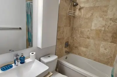 a bathroom with a sink and a toilet and a tub at Modern studio High Floor ,CN Tower, ScotiaArena in Toronto