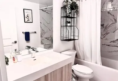a white bathroom with a sink and a toilet at Elegant Condo Near Eaton Centre Mall in Toronto