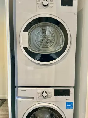 a washing machine and a dryer in a room at Elegant Condo Near Eaton Centre Mall in Toronto