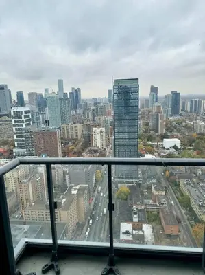 a view of a city skyline from a window at Elegant Condo Near Eaton Centre Mall in Toronto