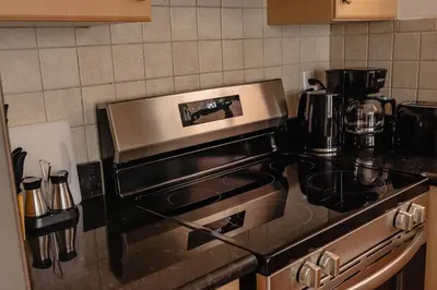 a kitchen with a stove top oven in a kitchen at Lum The Queen in Toronto