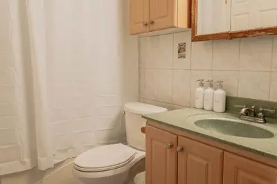 a bathroom with a toilet and a sink at Lum The Queen in Toronto