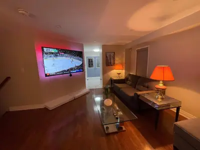 a living room with a couch and a tv on the wall at Finesse in Whitby