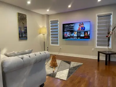 a living room with a couch and a flat screen tv at Finesse in Whitby