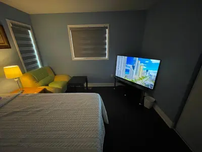 a hotel room with a bed and a flat screen tv at Finesse in Whitby