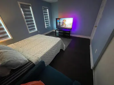 a bedroom with a bed and a flat screen tv at Finesse in Whitby