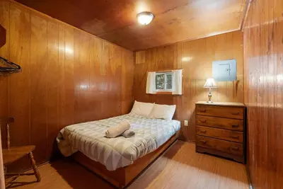 a small bedroom with a bed and a dresser at Dive into Nature in Bailieboro