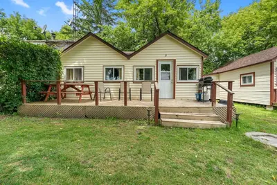 a house with a deck with a picnic table at Dive into Nature in Bailieboro