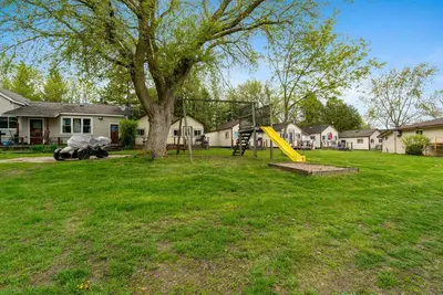 a playground in a yard with a yellow slide at Dive into Nature in Bailieboro