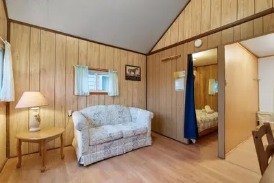 a living room with a chair and a bed at Enjoy Rice Lakes in Bailieboro