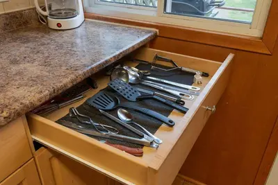 a drawer filled with cooking utensils on a kitchen counter at Enjoy Rice Lakes in Bailieboro