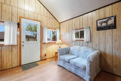 a living room with a couch and a door at Enjoy Rice Lakes in Bailieboro