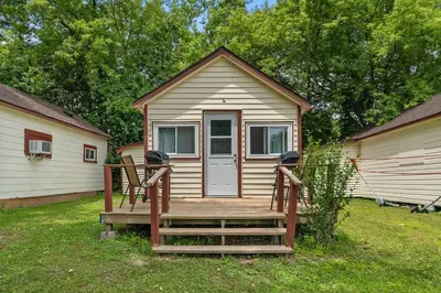 a tiny house with a wooden porch and a door at Enjoy Rice Lakes in Bailieboro