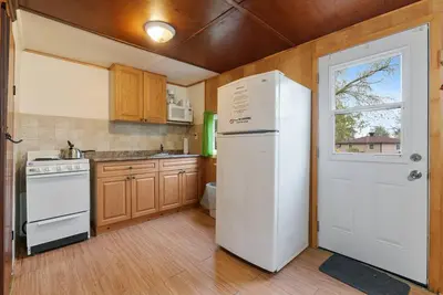 a kitchen with a white refrigerator and a window at Enjoy the Outdoors in Bailieboro